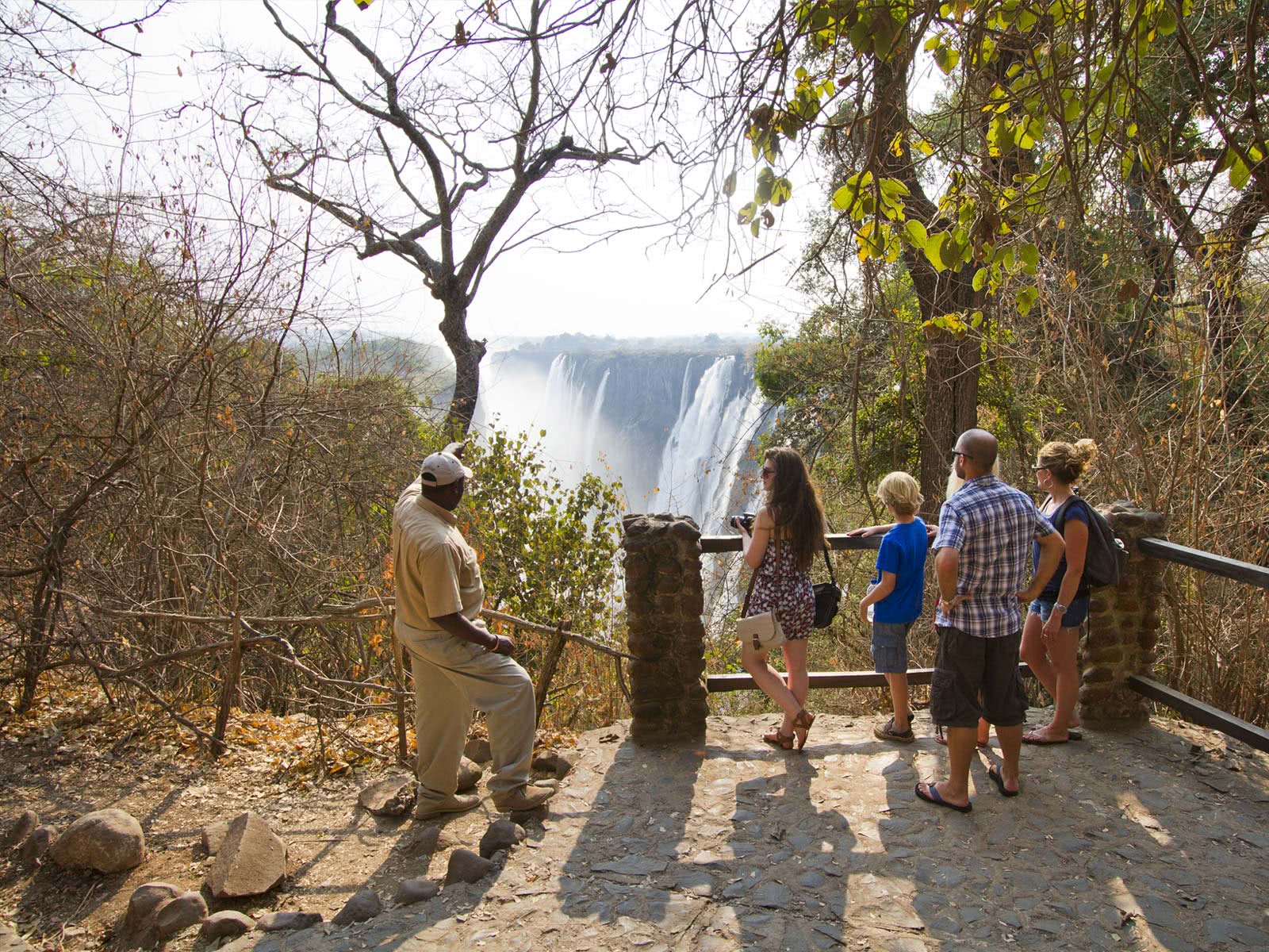 Guide leading a group of tourists on a tour of the Victoria Falls